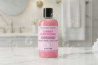 Bottle of Cherry Cheesecake body wash with pink label on white background