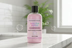 Pink bottle of Sakura Japan body wash with colorful text on a white background