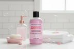 Pink bottle of strawberry French toast body wash with black cap on white background