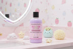 Bottle of Sugared Lychee body wash on a pink vanity with decorative items.